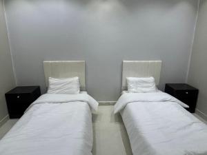 Ένα ή περισσότερα κρεβάτια σε δωμάτιο στο شاليهات الفخامة