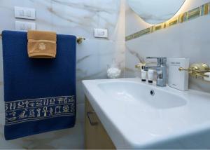 a bathroom with a sink and a blue towel at Rizkian pyramids view INN in Cairo