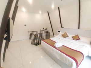 a bedroom with a bed and a staircase at Bethel Cottage in Kanthalloor
