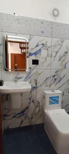 a bathroom with a sink and a toilet and a mirror at Bethel Cottage in Kanthalloor