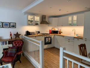 a kitchen with white cabinets and a counter top at Olive Tree Apartment Hove in Brighton & Hove