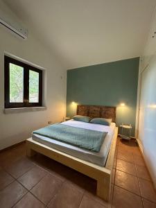 Ένα ή περισσότερα κρεβάτια σε δωμάτιο στο A Casuzza di Poggio Scopello