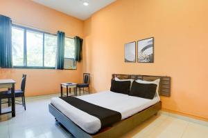 Ένα ή περισσότερα κρεβάτια σε δωμάτιο στο Hotel O Kumar's Amantran Lodging