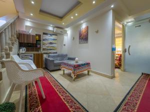 a living room with a table and a couch at Villa 53 Hotel Luxury Suites by Pharaohs Hospitality in Sheikh Zayed