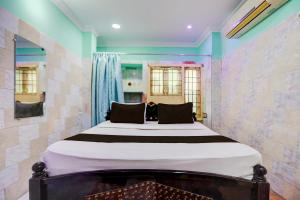 a bedroom with a large bed in a room at Hotel O Surya Lodge in Guntūr