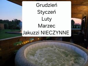a large tub of water on a balcony with the words garden sweep utility market at Domek całoroczny MAGJAN z sauną in Złotów
