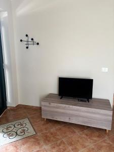 a flat screen tv sitting on top of a wooden table at Elegante bilocale a due passi dal centro in Saluggia