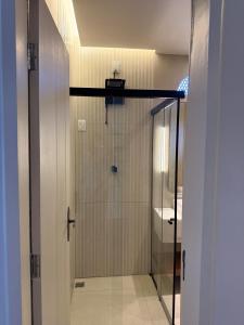 a shower with a glass door in a bathroom at Pousada Macamirim in Macaíba +16 photos