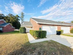 a brick house with a garage and a driveway at Eastgate 9A Beautiful Townhouse in Hammond