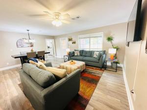 a living room with two couches and a piano at Eastgate 9A Beautiful Townhouse in Hammond