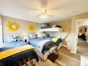 a bedroom with two beds and a ceiling fan at Eastgate 9A Beautiful Townhouse in Hammond