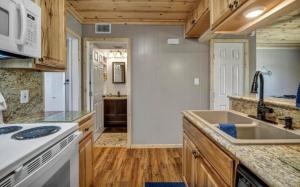 a kitchen with a sink and a counter top at Waterfront Getaway Lake Access Deck BBQ Grill in Kingsland +17 photos