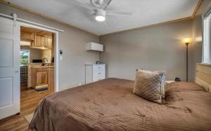 a bedroom with a bed with a ceiling fan at Waterfront Getaway Lake Access Deck BBQ Grill in Kingsland