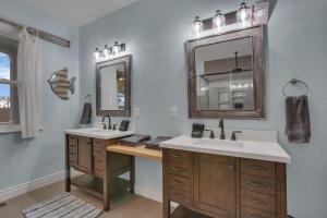 a bathroom with two sinks and a mirror at The Lakehouse in Buckeye Lake +55 photos