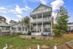 a large white house with a porch at The Lakehouse in Buckeye Lake