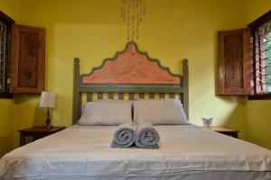 a bedroom with a bed with two towels on it at Casa Almendras - Magic Stay in Ometepe in Santa Cruz