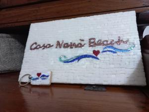 a cake with the words god nomamed back on it at Casa Nanà Beach in Lido Adriano