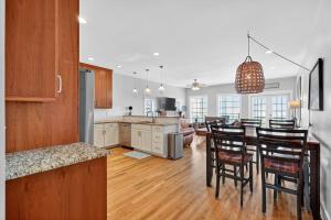 a kitchen and dining room with a table and chairs at After Dune Delight in Kure Beach