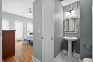 a bathroom with a sink and a mirror at After Dune Delight in Kure Beach +47 photos