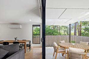 a living room with a couch and a table at Woodalla Way - Family Coastal Duplex Walk to Beach in Narrawallee
