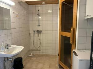 a bathroom with a shower and a sink at Convenient Apartment for 4 with Sauna in Törnävä