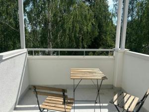a bench and a table on a balcony at Convenient Apartment for 4 with Sauna in Törnävä