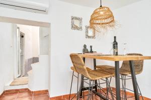 - une salle à manger avec une table et des tabourets dans l'établissement La Casita Turquesa - Zeezicht, à Almuñécar