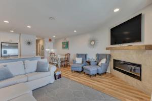 a living room with a couch and a fireplace at Three Little Birds in Kure Beach