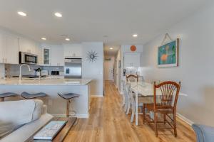 a kitchen and living room with a couch and a table at Three Little Birds in Kure Beach