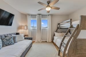 a living room with a couch and a bunk bed at Three Little Birds in Kure Beach +41 photos