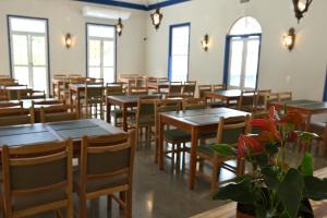 a room filled with tables and chairs and windows at Quinta das Águas Hotel in Itapira
