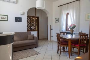 a living room with a table and a couch at Al Primo Piano in Forio d'Ischia