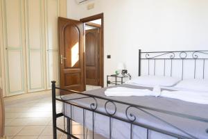 a bedroom with a bed and a wooden door at Al Primo Piano in Forio d'Ischia +23 photos