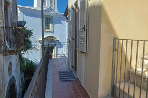 an alley with an open door on a building at Al Primo Piano in Forio d'Ischia