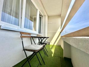 ein Balkon mit zwei Stühlen und einem Fenster in der Unterkunft Bratislava centrum apartment in Bratislava