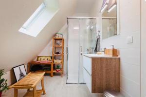 a bathroom with a shower and a sink and a table at Envol du Phénix - Studio Phenix 20 m² avec jardin in Plouédern