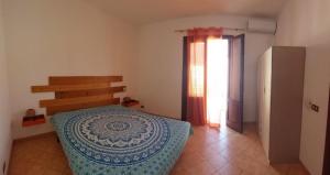 a bedroom with a bed in a room with a window at Casetta La Meridiana in San Vito lo Capo