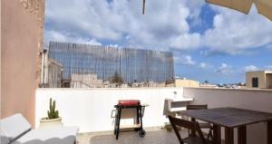 a balcony with a table and a view of a building at Casetta La Meridiana in San Vito lo Capo