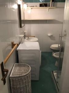 a bathroom with a sink and a toilet at Appartamento Gelsomino vista mare in Monte Petrosu