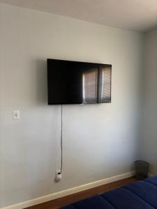 a flat screen tv on the wall of a bedroom at Classic 2 bed 1 bath home in the cradle of beautiful Valdosta in Valdosta
