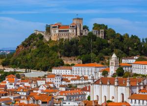 a view of a city with a castle on a hill at Pedrogão Soul & Sunset in Pedrógão