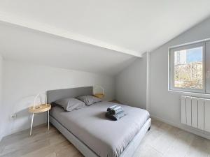 a bedroom with a bed with a backpack on it at Appartement confortable Oullins centre in Oullins
