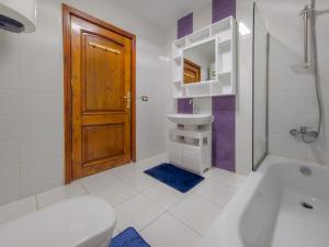 a bathroom with a toilet and a sink and a door at Villa 53 Hotel Luxury Suites by Pharaohs Hospitality in Sheikh Zayed +80 photos