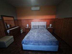 a bedroom with a large bed and two night stands at Quinta do silva in Celorico de Basto