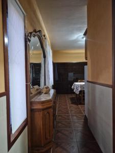 a bathroom with a wooden vanity and a mirror at Quinta do silva in Celorico de Basto