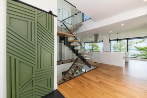a room with green sliding doors and a staircase at Le Föss, Fleuve, Sauna & Spa in Petite-Rivière-Saint-François +35 photos