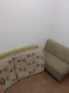 a couch sitting on the floor in a room at Apto 2 dorm com elevador in São Vicente