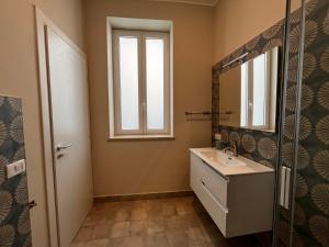 a bathroom with a sink and a mirror at Artop in Messina +18 photos