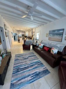 a living room with a couch and a rug at Waterfront Boat Lift Bungalow in St Pete Beach