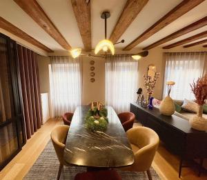 a living room with a dining table and chairs at Luxury apartment in the city center in Strasbourg